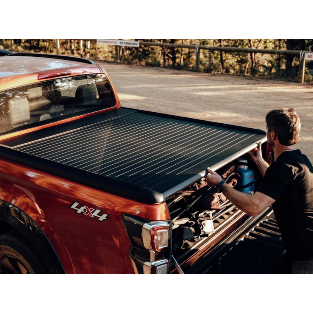 Couvre-benne manuel Mountain Top EVOm pour Mitsubishi L200 2019+ Double Cab, en tissu robuste, installé sur la benne du véhicule.