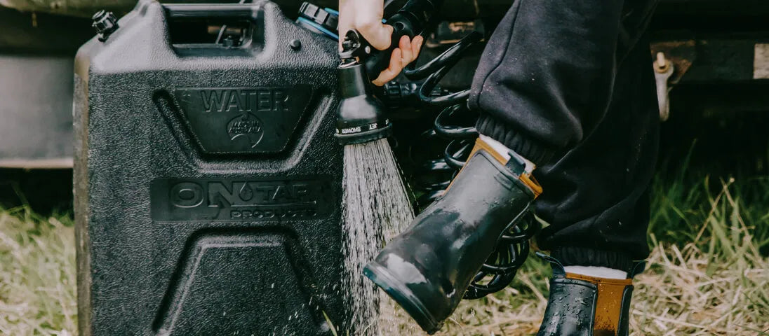 Douche portable ONTAP Black Edition par ARB4x4, compacte et pratique, avec tuyau et pommeau pour utilisation en extérieur.