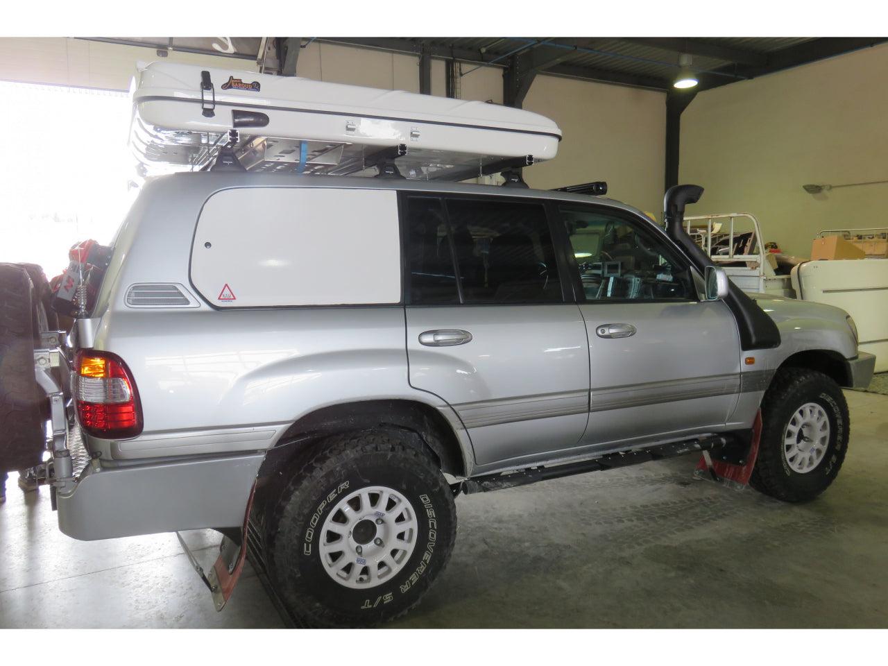 Support d’échelle sous tente James Baroud N4 Offroad, accessoire pour tente de toit, en métal robuste, installé sous la tente.