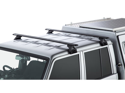 Kit 2 barres de toit Rhino-Rack Sportz 1500mm pour Toyota Land Cruiser HZJ79, double cab, avec fixation robuste.